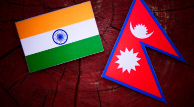 Indian flag with Nepali flag on a tree stump isolated